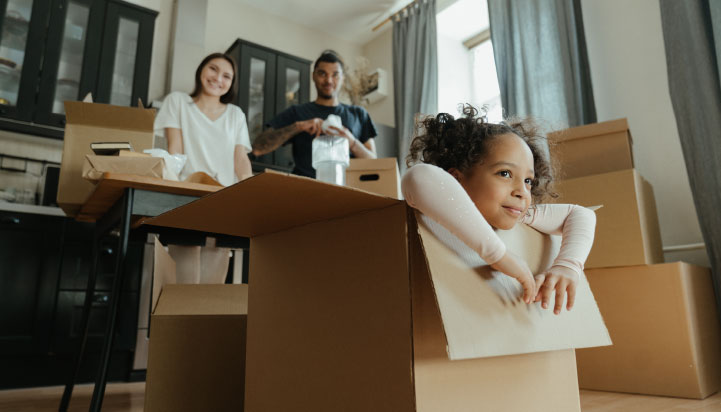 Financial wellness | Image of girl and parents unpacking