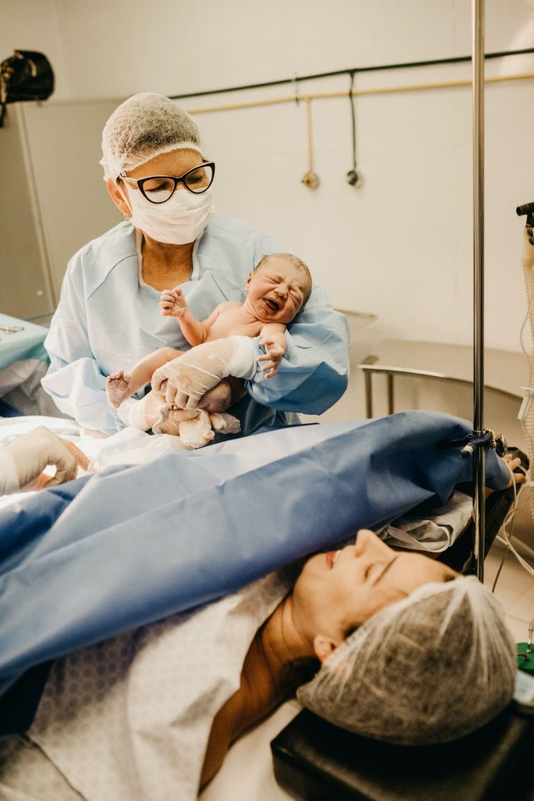 Women sees her child for the first time after a C-section.